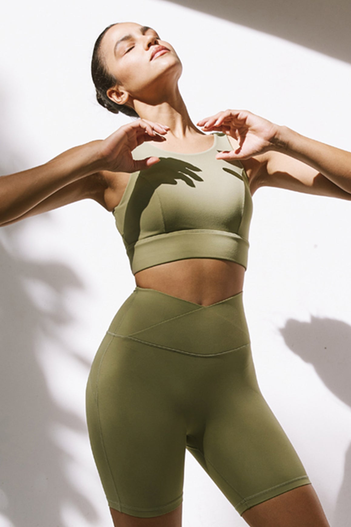 WISKII Move Freely back cutout sports bra in muted khaki, featuring a supportive design and stylish back cutouts for active wear.
