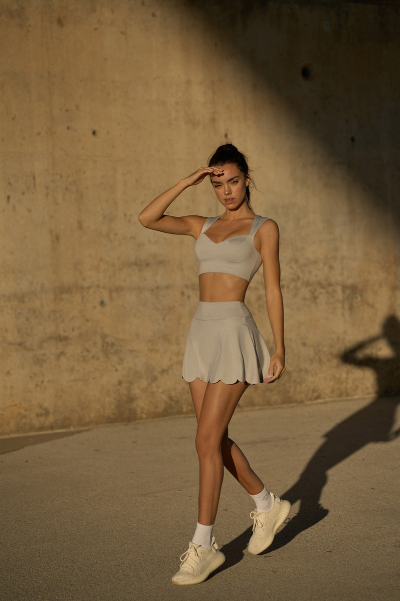 Model wears WISKII high waist a line tennis skirt