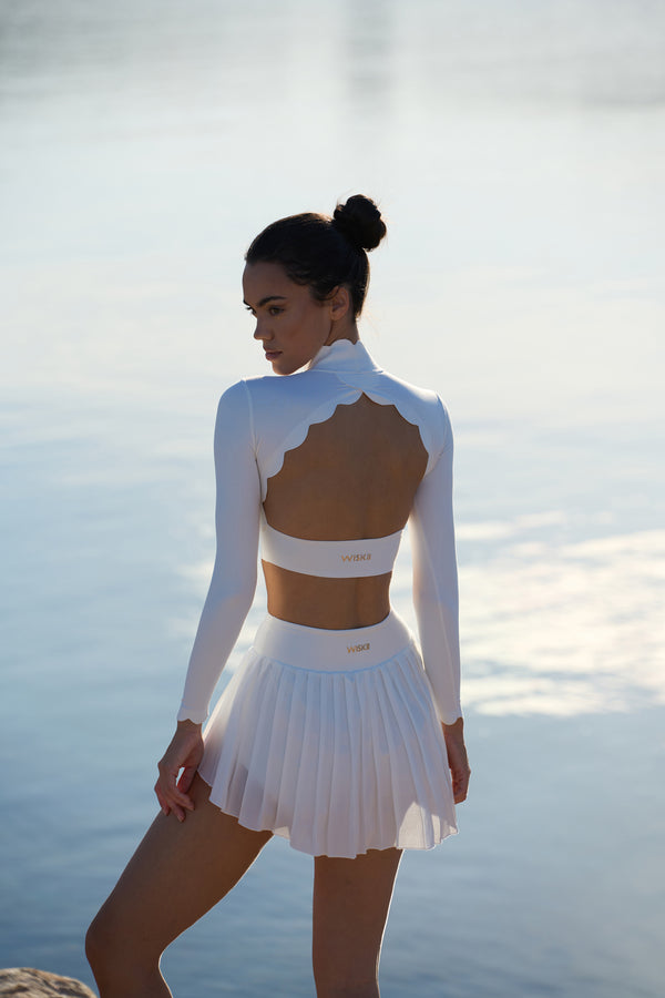 model wears a WISKII Lite Pleated Skirts