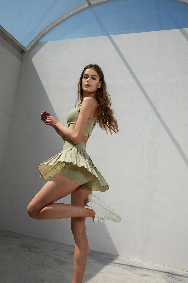 model wears a WISKII Lite Pleated Skirts