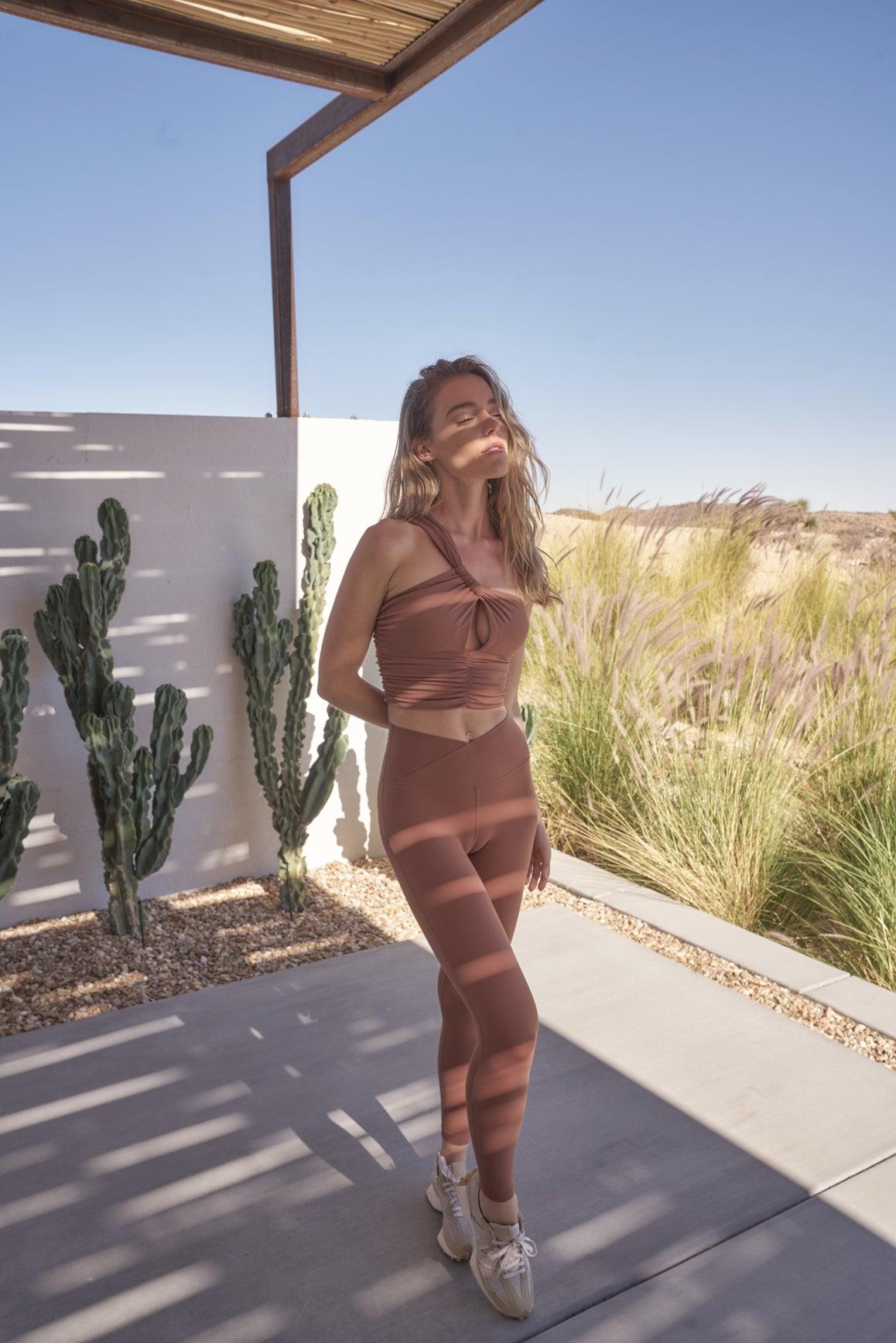 WISKII ivory one-shoulder ruched sports bra with stylish design and comfortable fit for activewear.