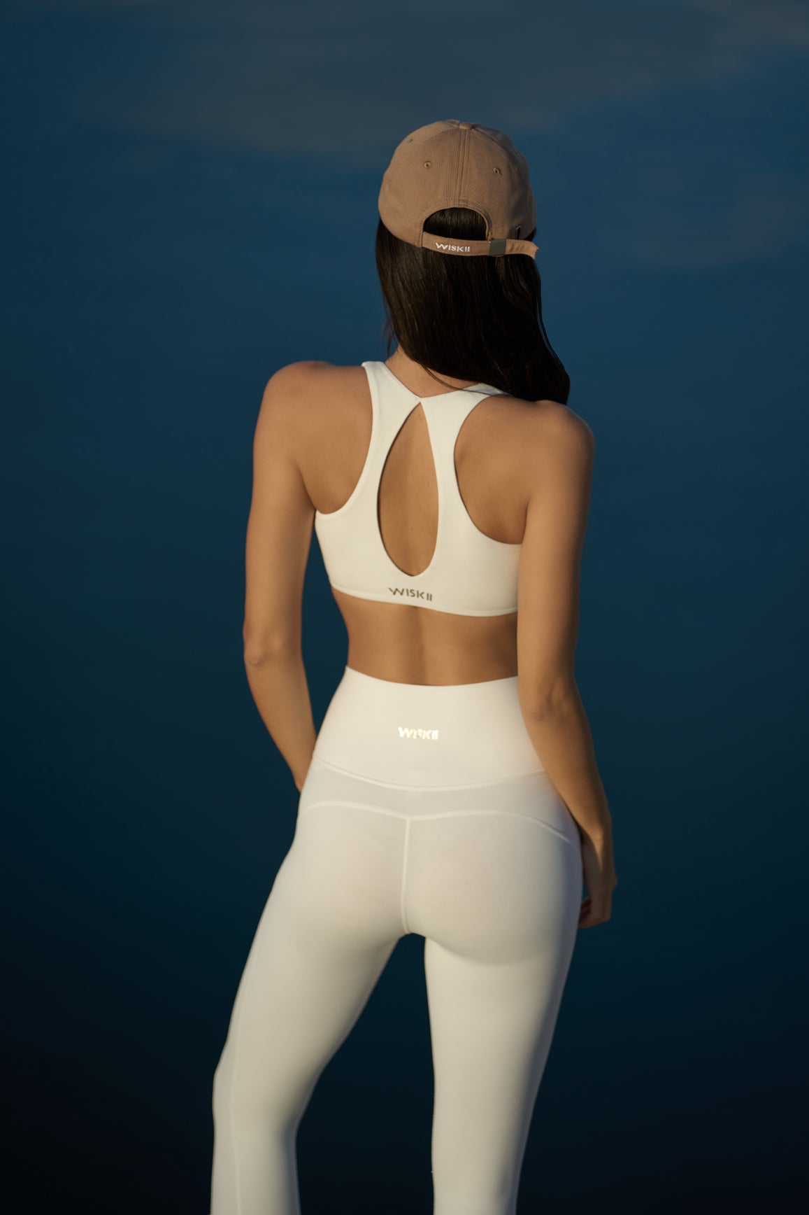 WISKII ruched sports bra in ivory, featuring a stylish design and comfortable fit for active wear.