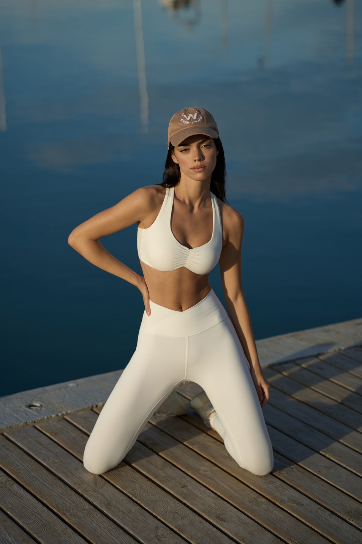 WISKII ivory ruched sports bra featuring adjustable straps and a comfortable fit for active wear.